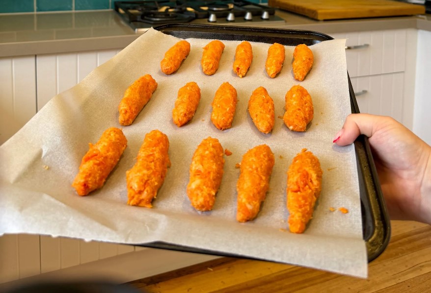 Sweet potato and carrot tots on a bamboo baby plate